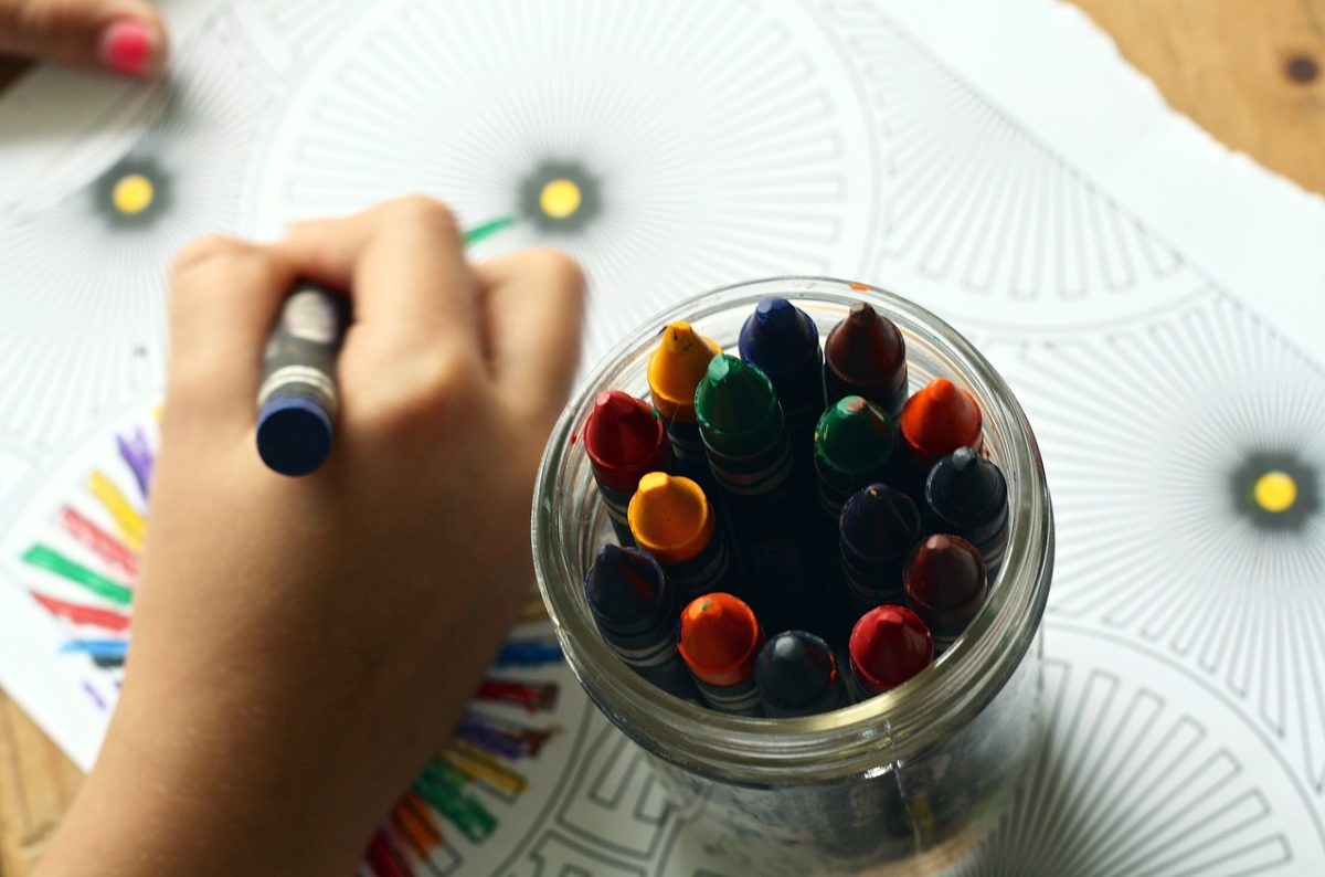 A child coloring with crayons.