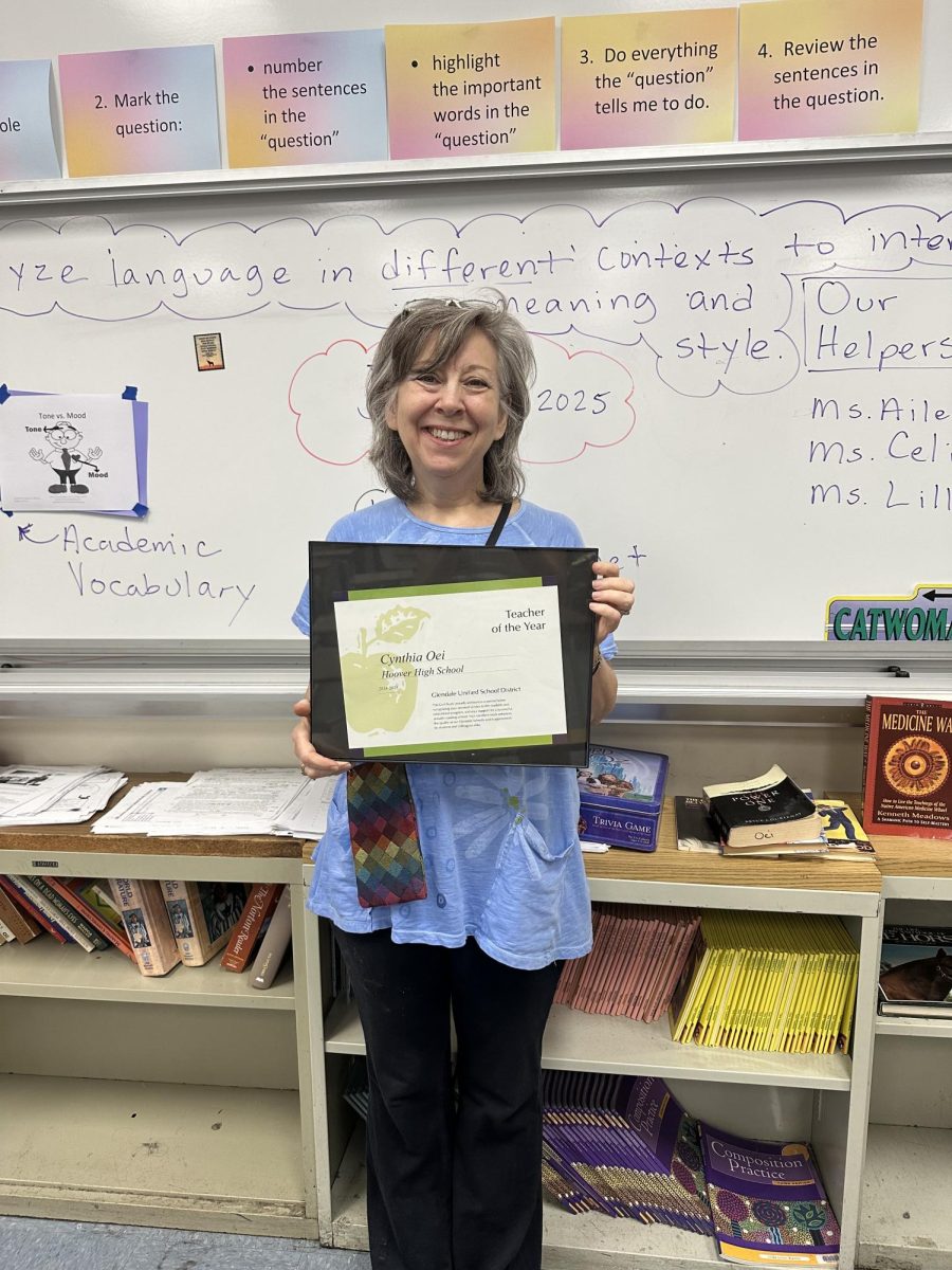 Mrs. Oei with her "Teacher of the Year" Award that was mentioned in the article